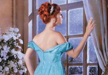 Picture of a young lady peering out of window with a sense of longing