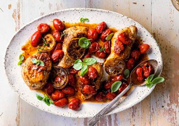 Plate of roast chicken with tomatoes