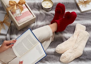 A reader with a book and comfortable socks