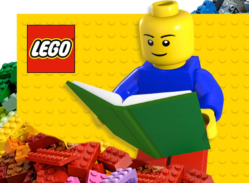 Lego character reading a book